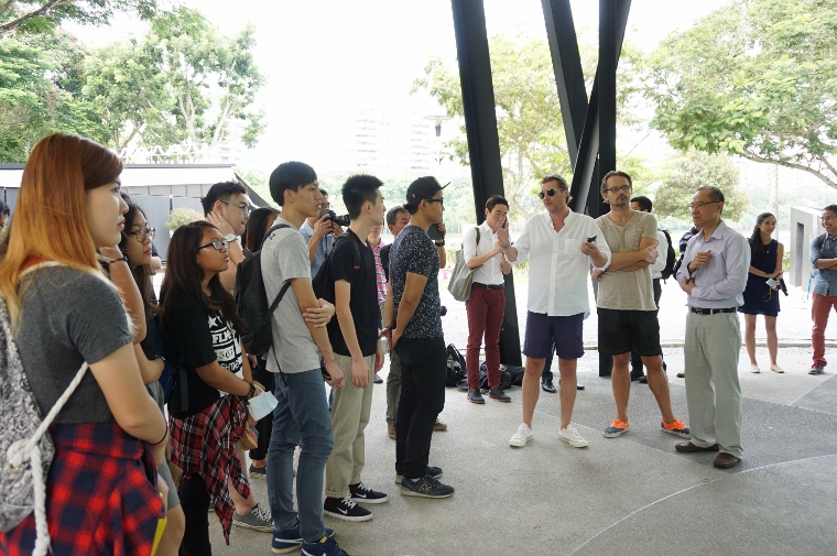 f explaining the mural to a group of Temasek Polytechnic students invited to paint the reverse side of the wall.