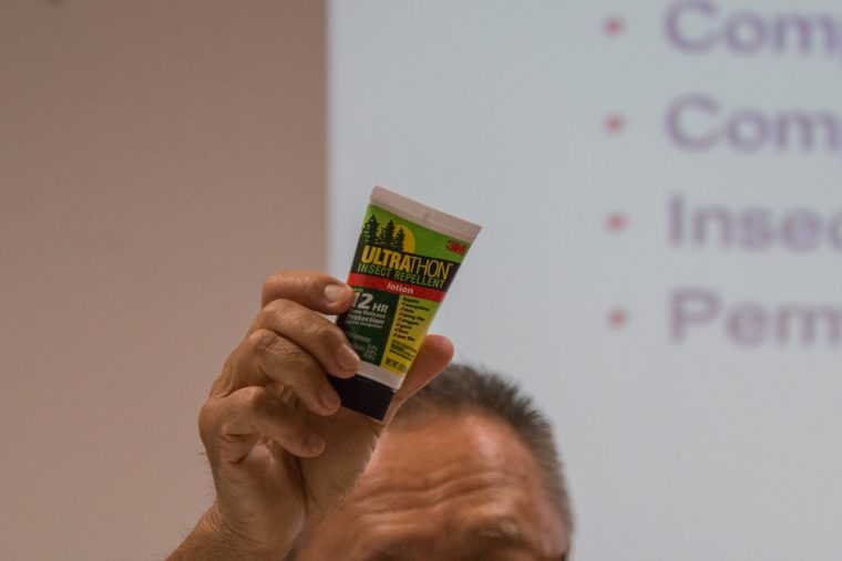 Singapore’s chef de mission holds up a tube of insect repellent, which will be included in the ‘bag of tricks’ for Singapore’s athletes. Photo: Ng Yi Shu