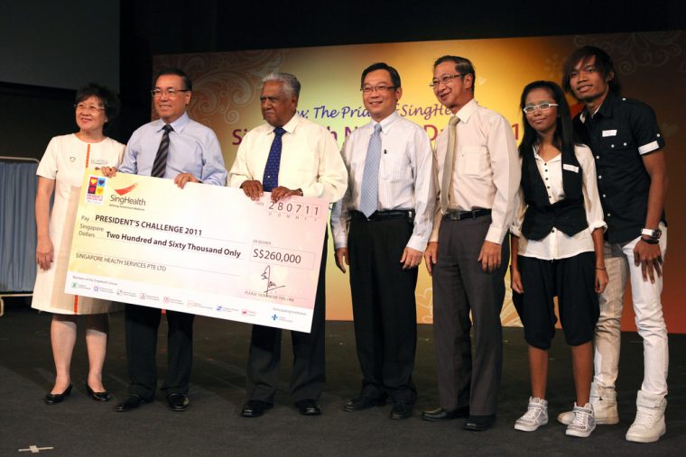 Nathan accepting cheque on behalf of the President's Challenge. Source. 