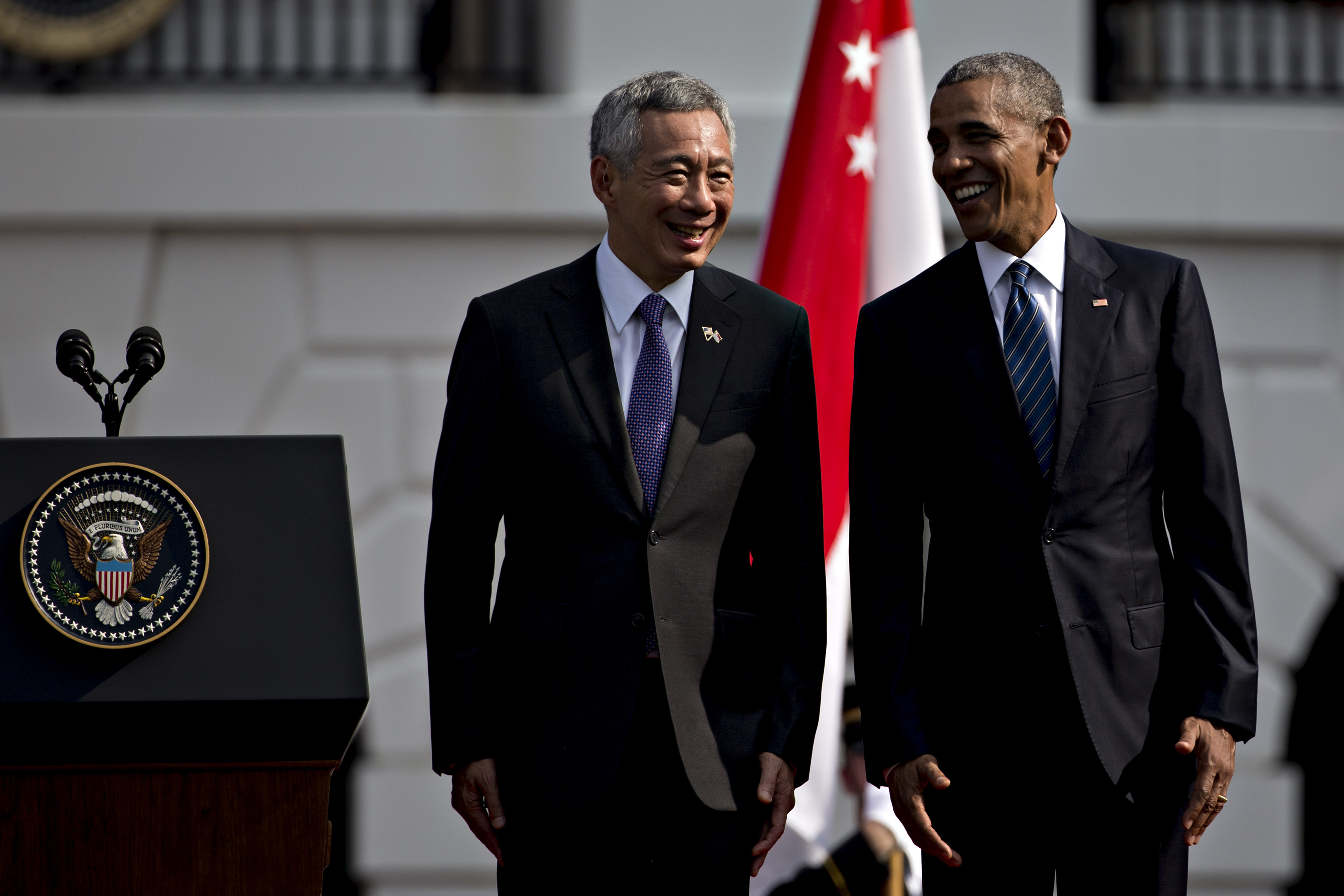 U.S. President Barack Obama, right, and Lee Hsien Loong, Singapore's prime minster, talk while participating in an official arrival ceremony on the South Lawn of the White House in Washington, D.C., U.S., on Tuesday, Aug. 2, 2016. The occasion marks first official visit by a Singapore prime minister since 1985. Photographer: Andrew Harrer/Bloomberg via Getty Images