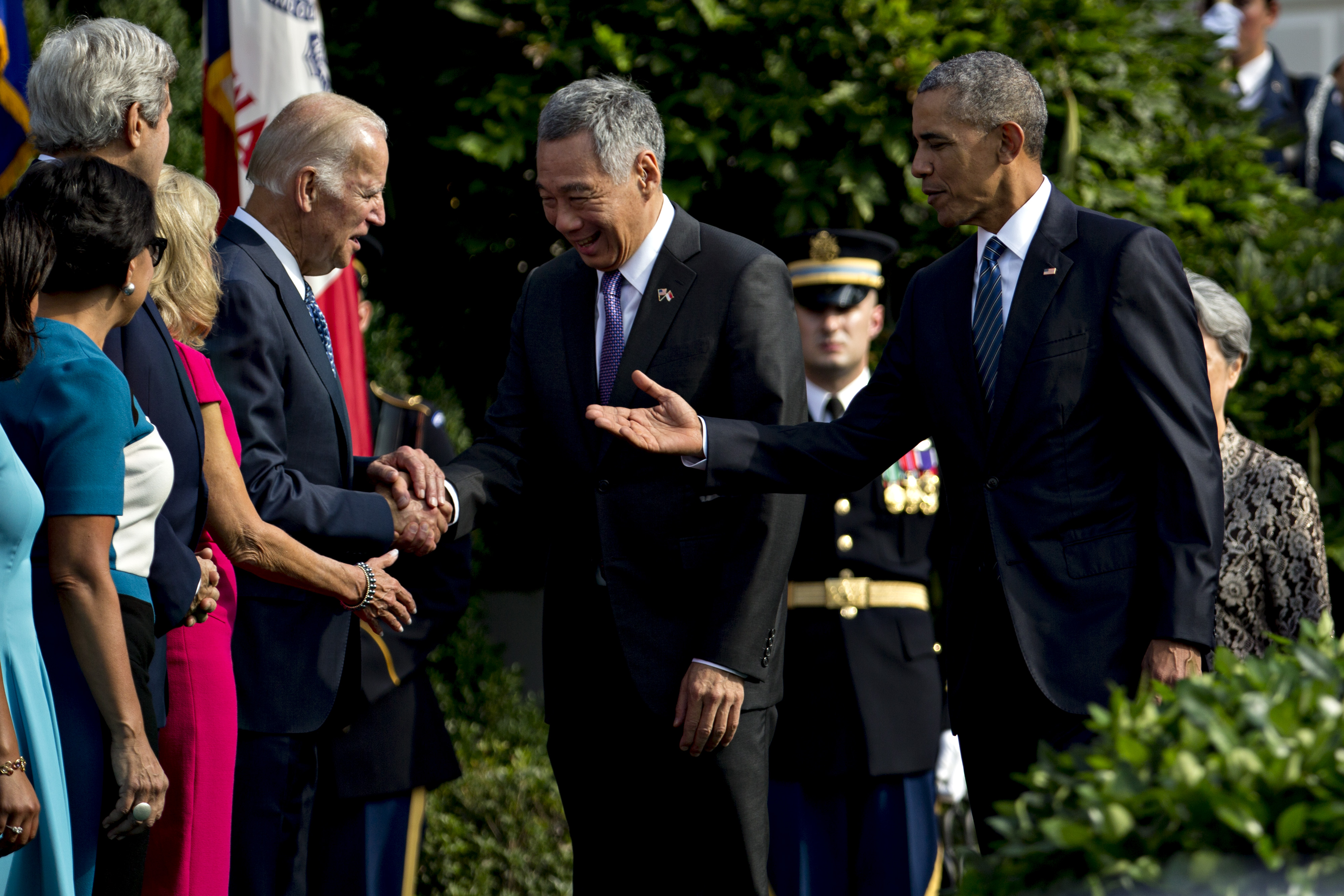 Lee Hsien Loong, Singapore's prime minster, center, greets U.S. Vice President Joseph "Joe" Biden with U.S. President Barack Obama, right, during an official arrival ceremony on the South Lawn of the White House in Washington, D.C., U.S., on Tuesday, Aug. 2, 2016. The occasion marks first official visit by a Singapore prime minister since 1985. Photographer: Andrew Harrer/Bloomberg via Getty Images