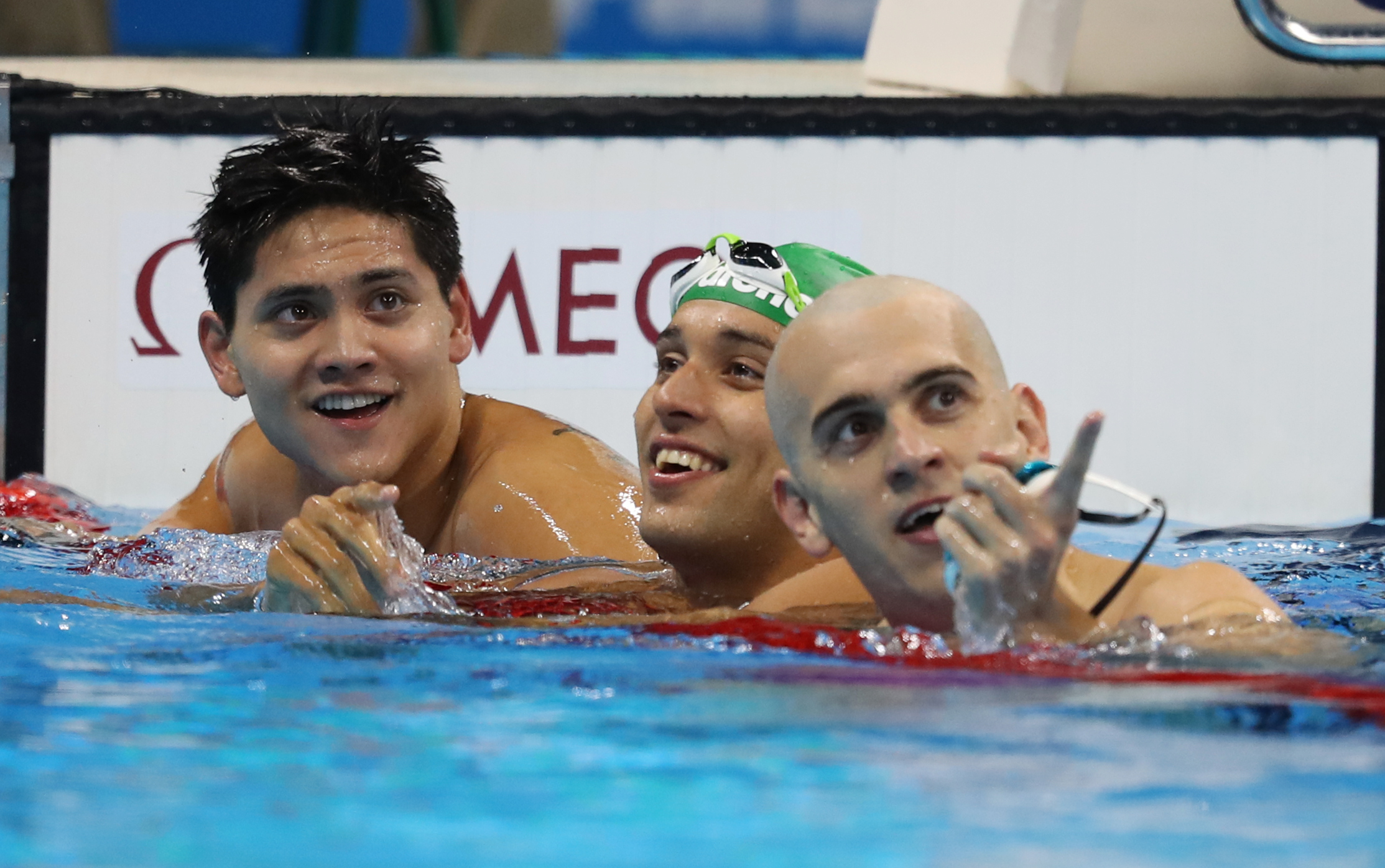 RIO DE JANEIRO, BRAZIL - AUGUST 12: Joseph Schooling of Singapore celebrates winning the Men's 100m Butterfly with Chad Le Clos and Laszlo Cseh on Day 7 of the Rio 2016 Olympic Games at the Olympic Aquatics Stadium on August 12, 2016 in Rio de Janeiro, Brazil. (Photo by Ian MacNicol/Getty Images)