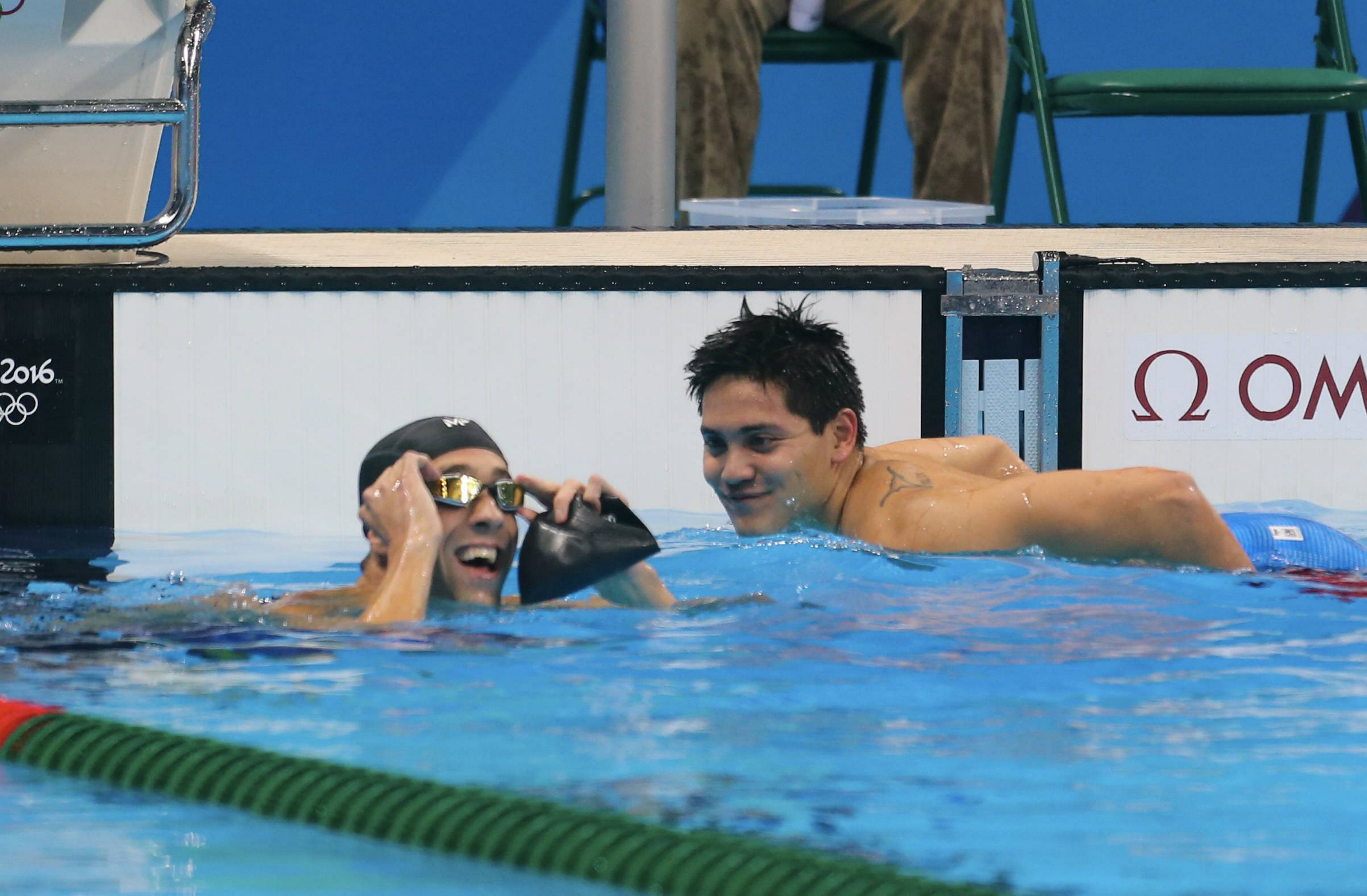 RIO DE JANEIRO, BRAZIL - AUGUST 12: Joseph Schooling of Singapour celebrates his victory with Michael Phelps of United States after the final men's 100m Butterfly at Olympic Aquatics Stadium on August 12, 2016 in Rio de Janeiro, Brazil. (Photo by Xavier Laine/Getty Images)