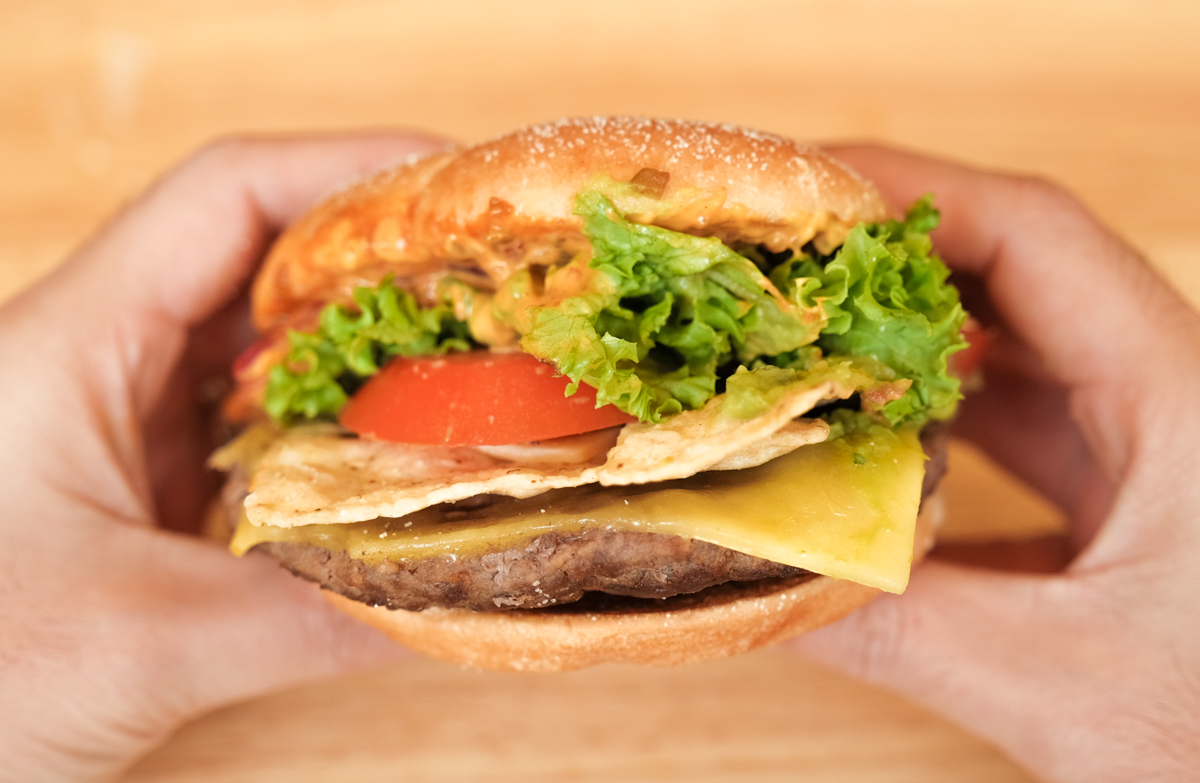mcdonalds premium signature series spicy tortilla burger hand hold front