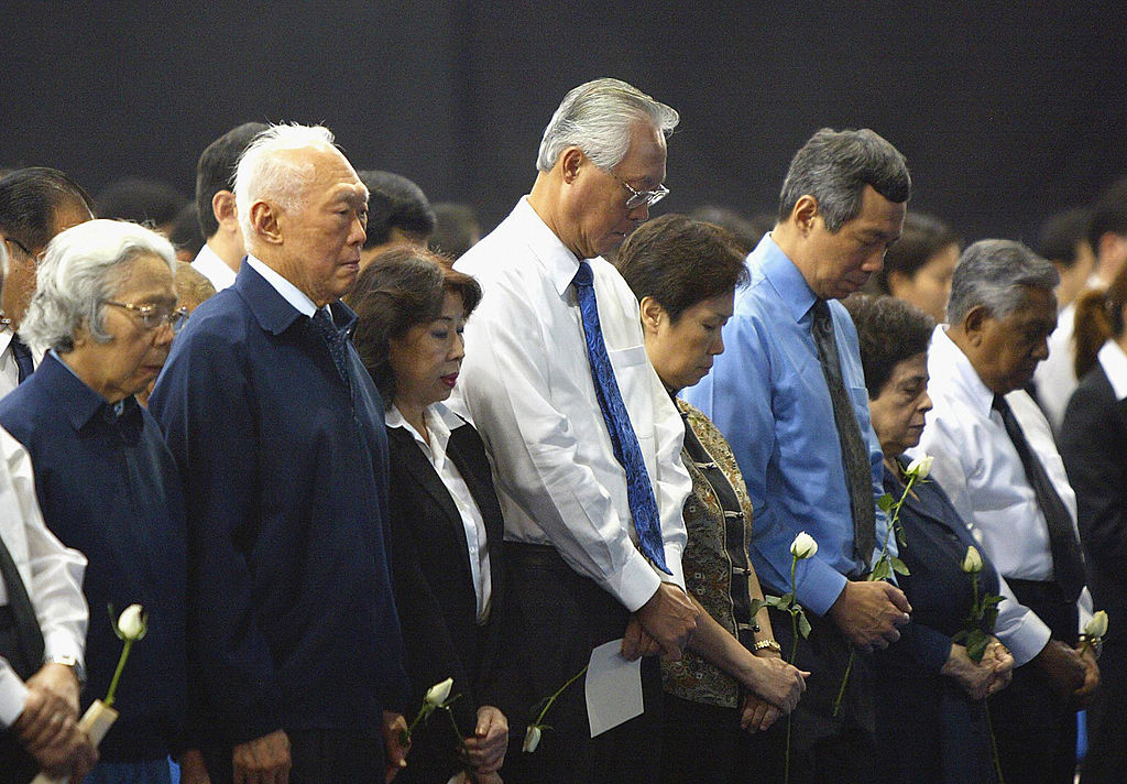SINGAPORE, SINGAPORE: Singaporean leaders with their spouses, Minister Mentor Lee Kuan Yew (2nd L), Senior Minister Goh Chok Tong (C), Prime Minister Lee Hsien Loong (3rd R) and President S.R Nathan (far R) attend a one minute silence for the tsumani victims during a Tsunami Disaster Memorial Service in Singapore, 09 January 2005. More than 5,000 people were expected to attend the memorial service in Singapore in remembrance of the nearly 160,000 who died in last month's Asian tsunami disaster. AFP PHOTO/ROSLAN RAHMAN (Photo credit should read ROSLAN RAHMAN/AFP/Getty Images)