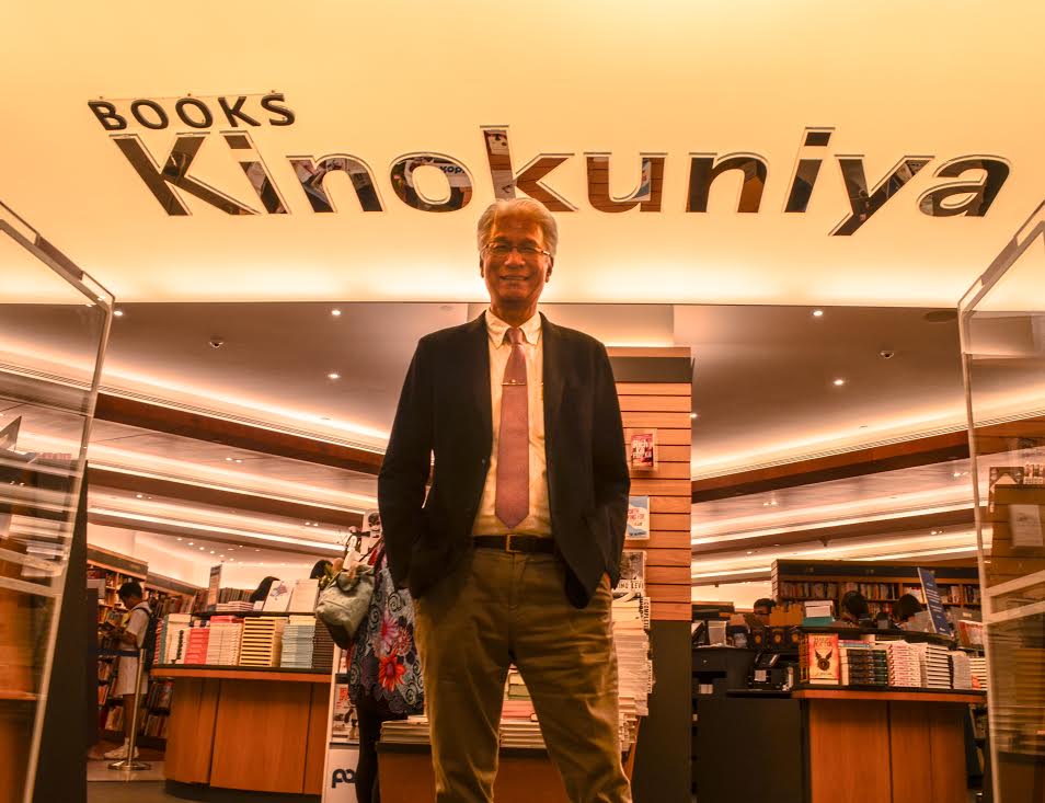 Chan under the Kinokuniya "mothership" light fixture at the rear entrance of the Ngee Ann City flagship bookstore. Photo by Juan Ezwan