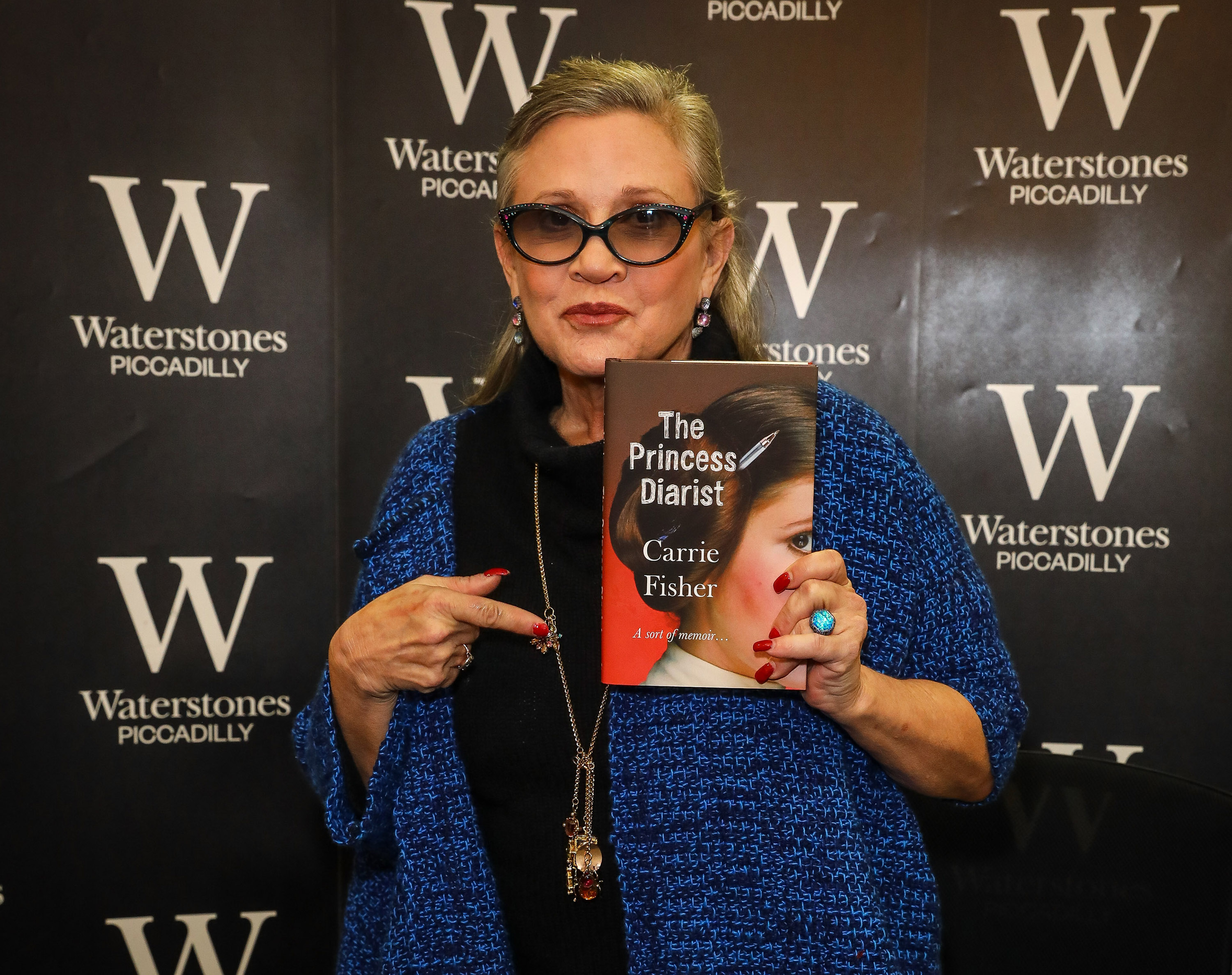 LONDON, ENGLAND - DECEMBER 11: Carrie Fisher signs copies of her new book "The Princess Diarist" at Waterstones, Piccadilly, on December 11, 2016 in London, England. (Photo by David M. Benett/Dave Benett/Getty Images)