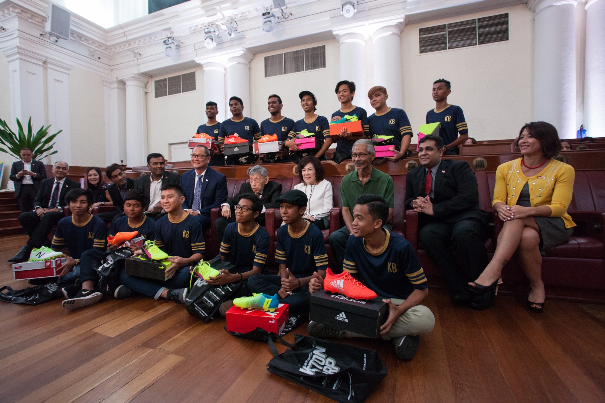 Members of the foundation's board with a group of its first beneficiaries, who have been given a pair of football boots. (Photo by Chiew Teng)