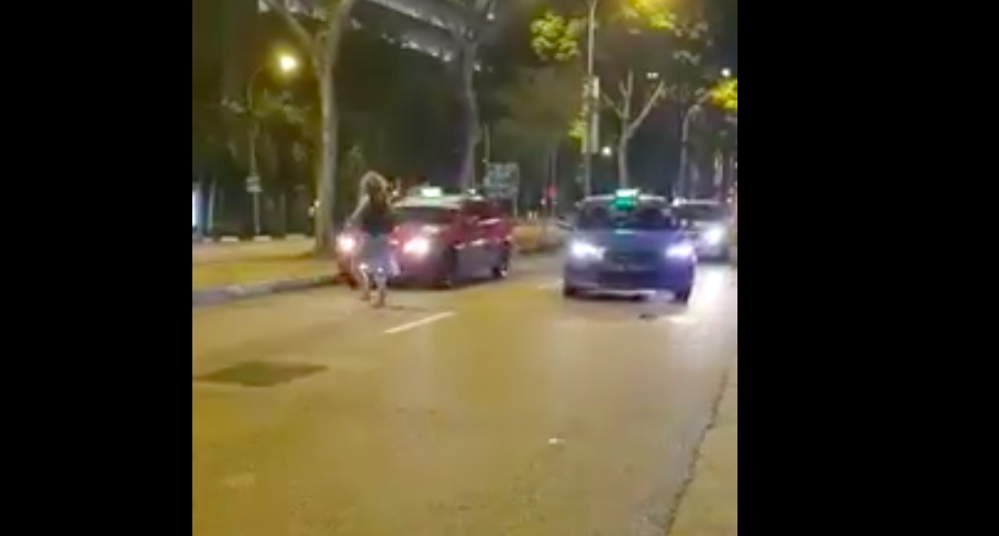 Lady walks drunkenly in middle of S'pore road, starts sleeping on top ...