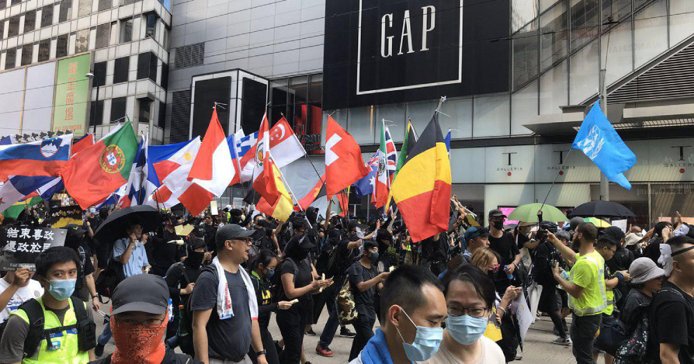 Hong Kong protesters wave international flags, including S'pore's