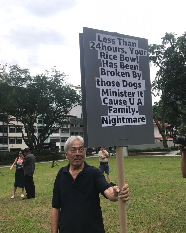 guy holding protest sign