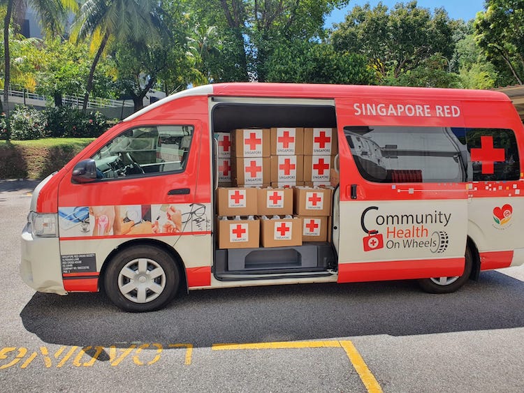 photo of Red Cross van donating masks and sanitisers