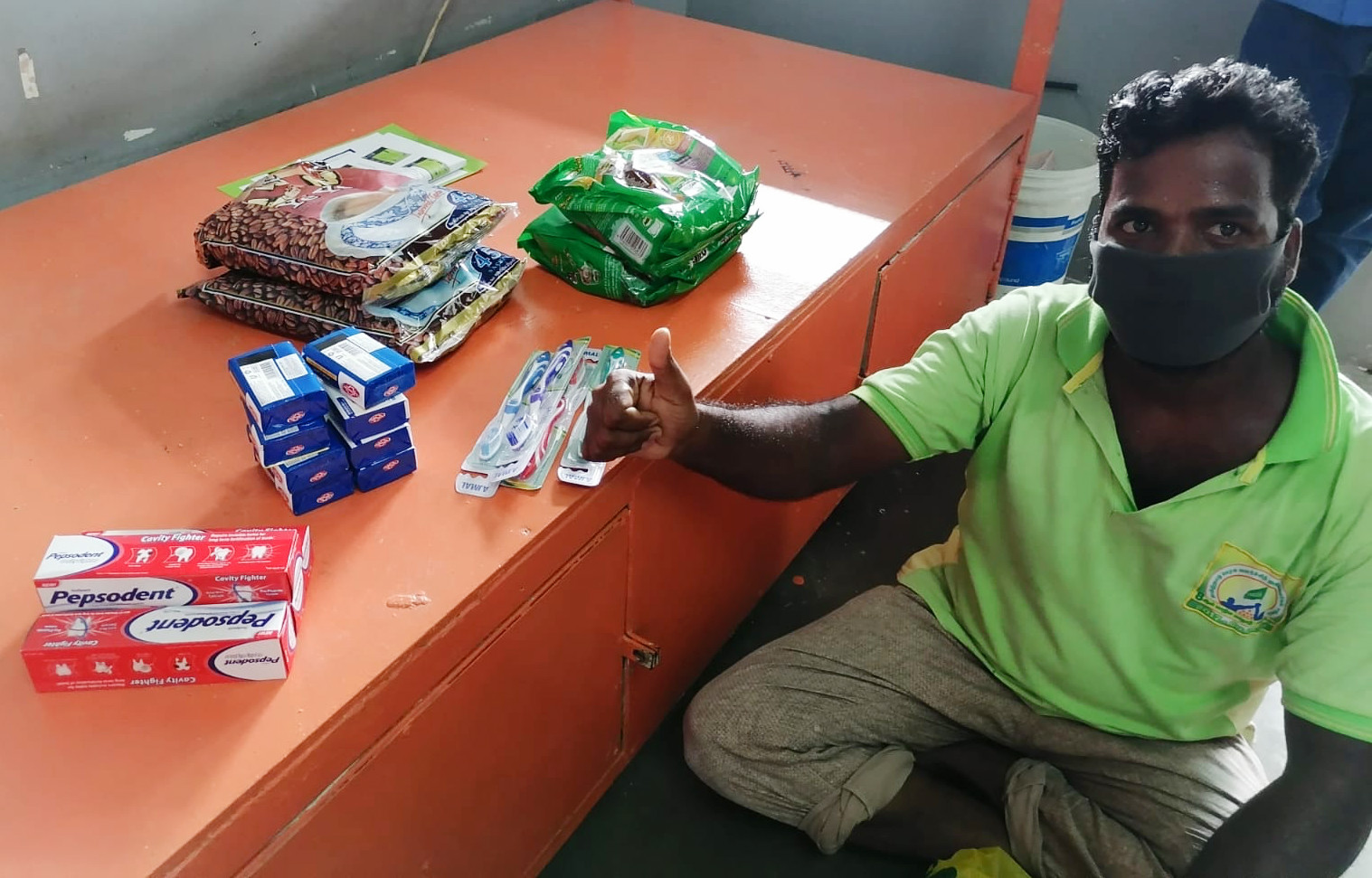 migrant worker in Singapore receiving donations from OCBC