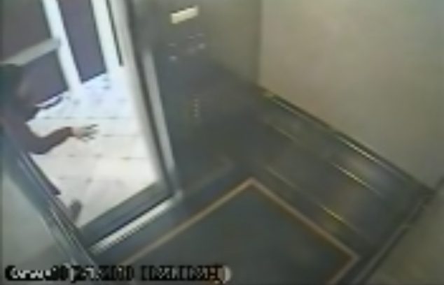 Screenshot from CCTV Footage of Lam gesturing weirdly outside the elevator