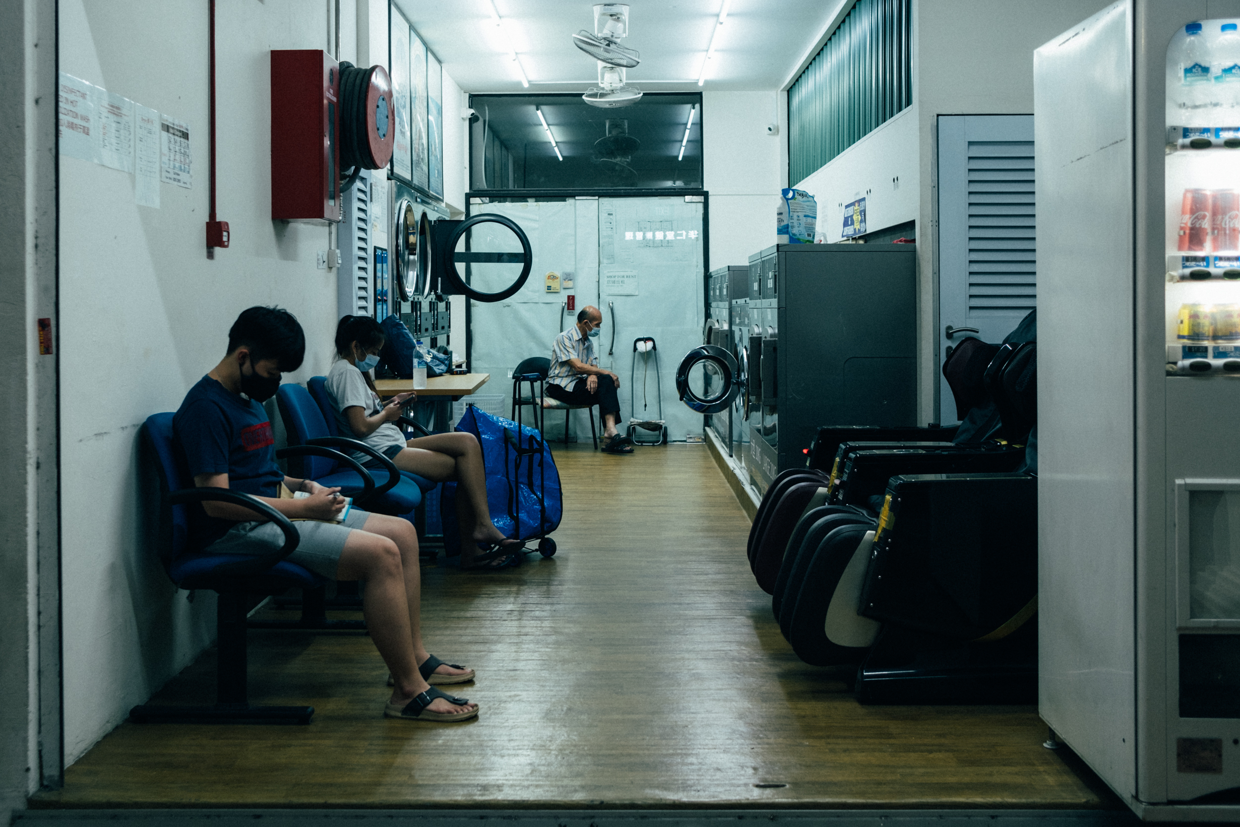 Image of people sitting in a laundromat