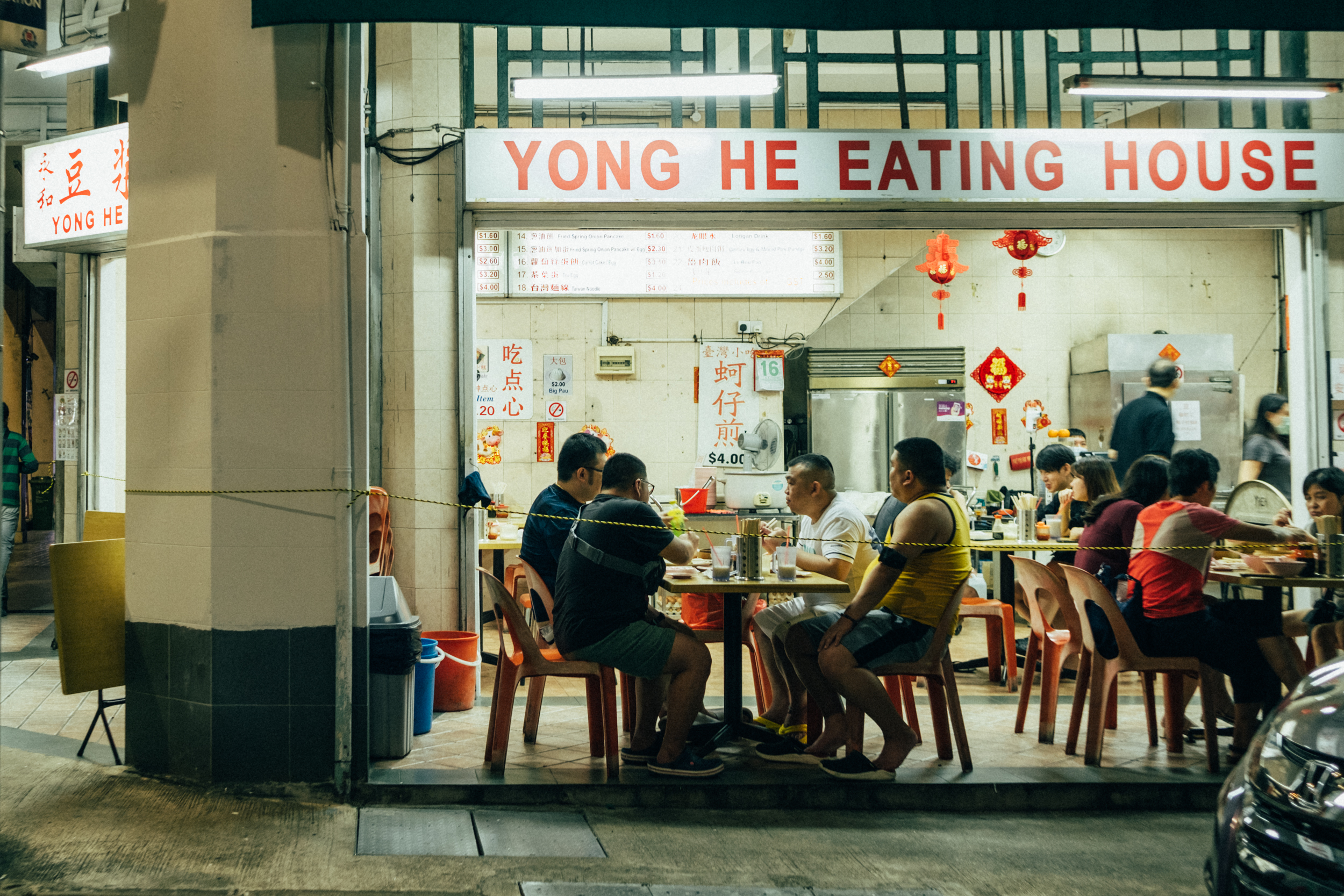 Image of people sitting at an eatery in Geylang