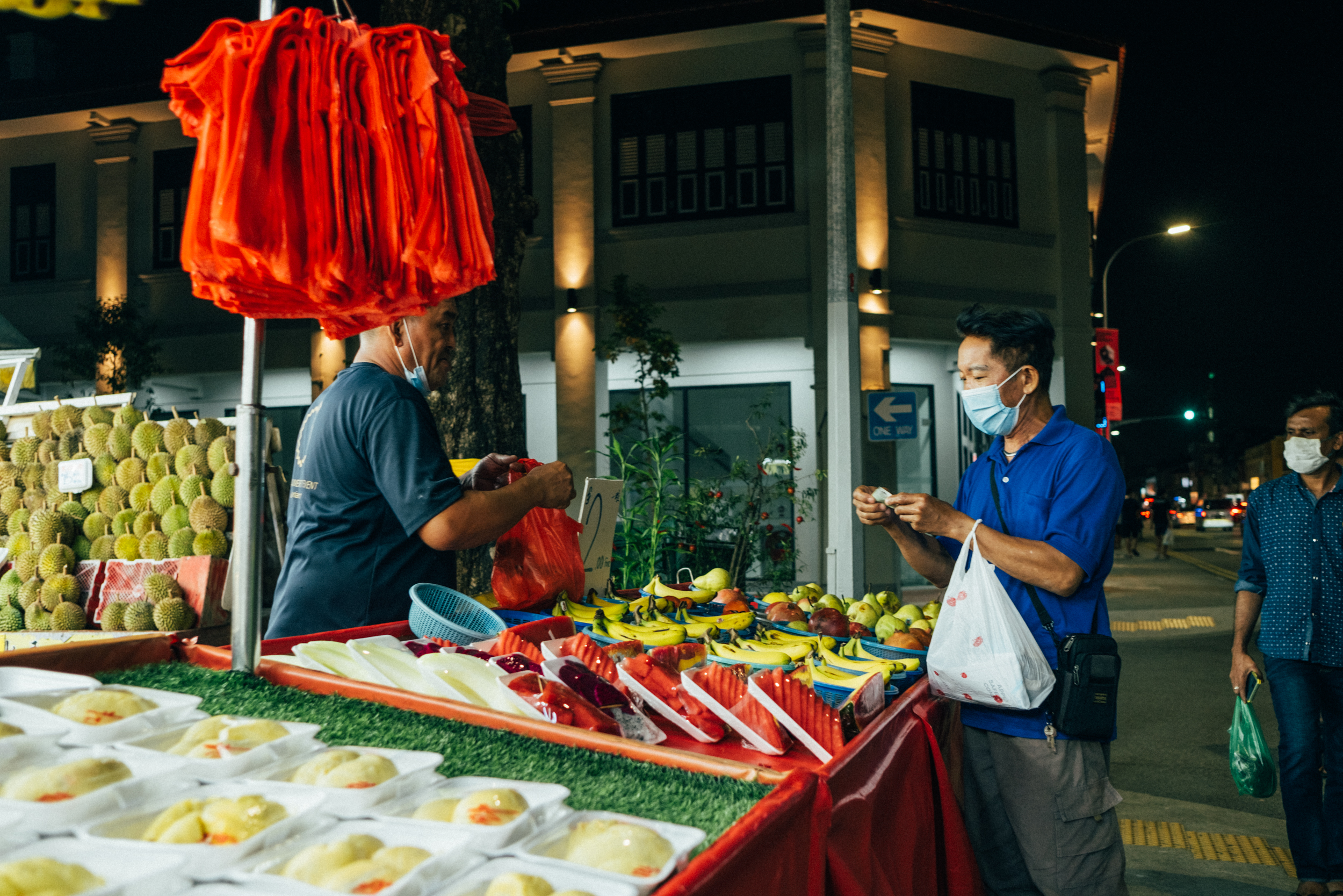 Image of a person buying fruits