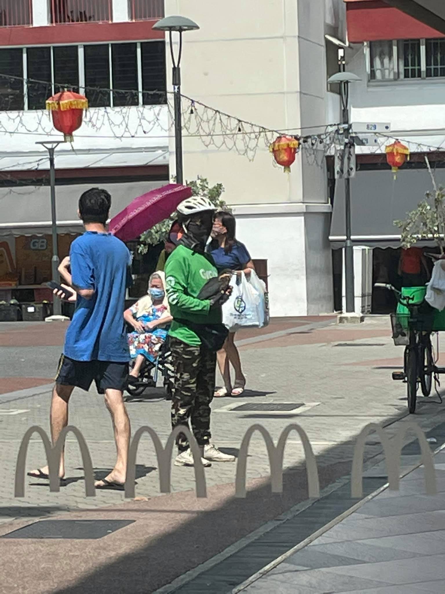 Image of a Grab Deliveryman holding the black bittern