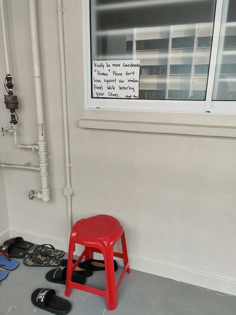 Chair placed under sign on window