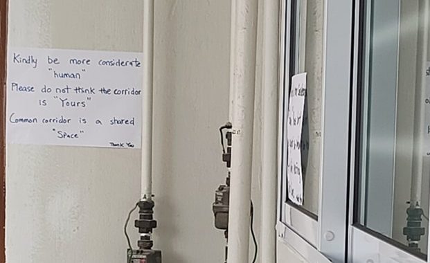 Handwritten notices on the wall and window
