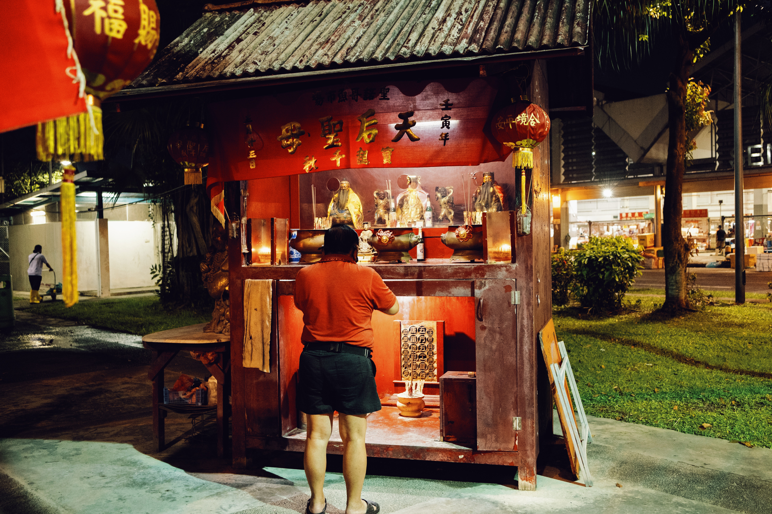 A worker at Senoko Fishery Port offers prayers at an alter outside the wholesale market. 