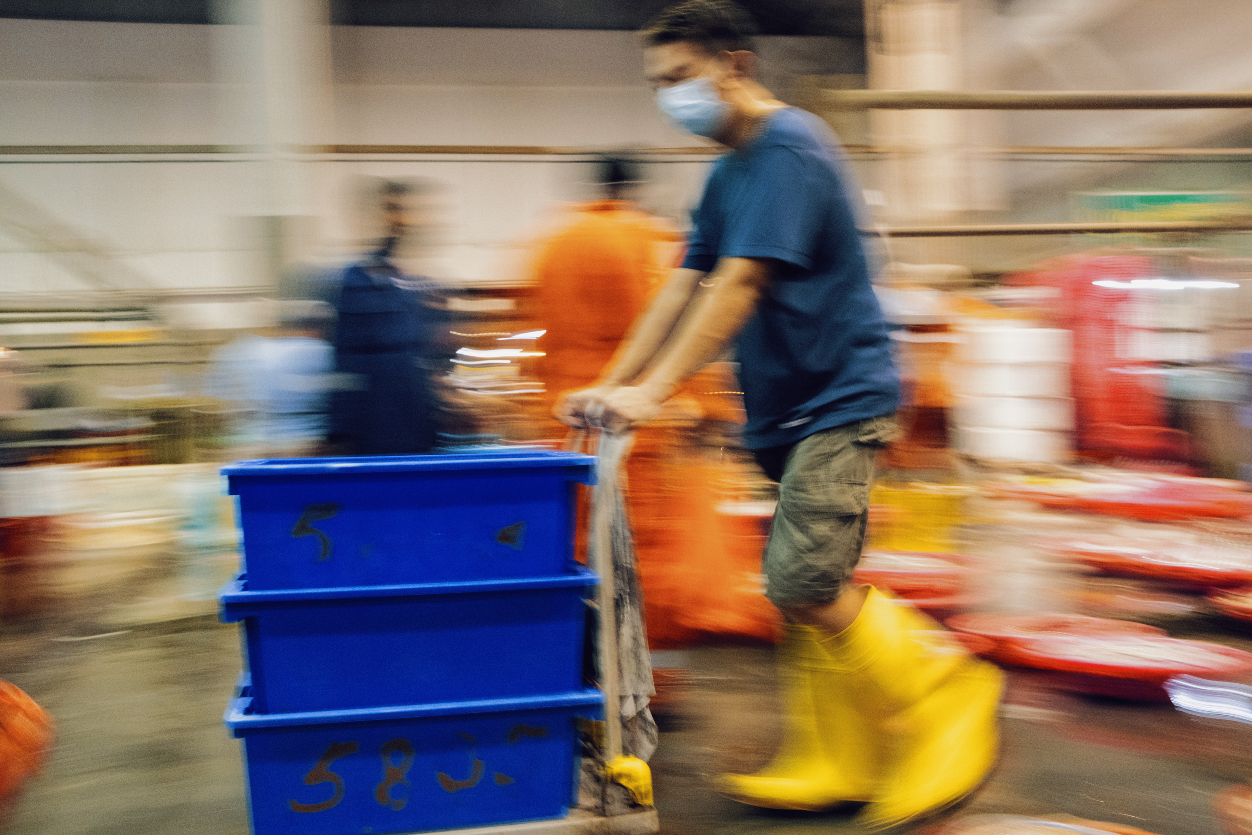 Workers rush through Senoko Fishery Port.