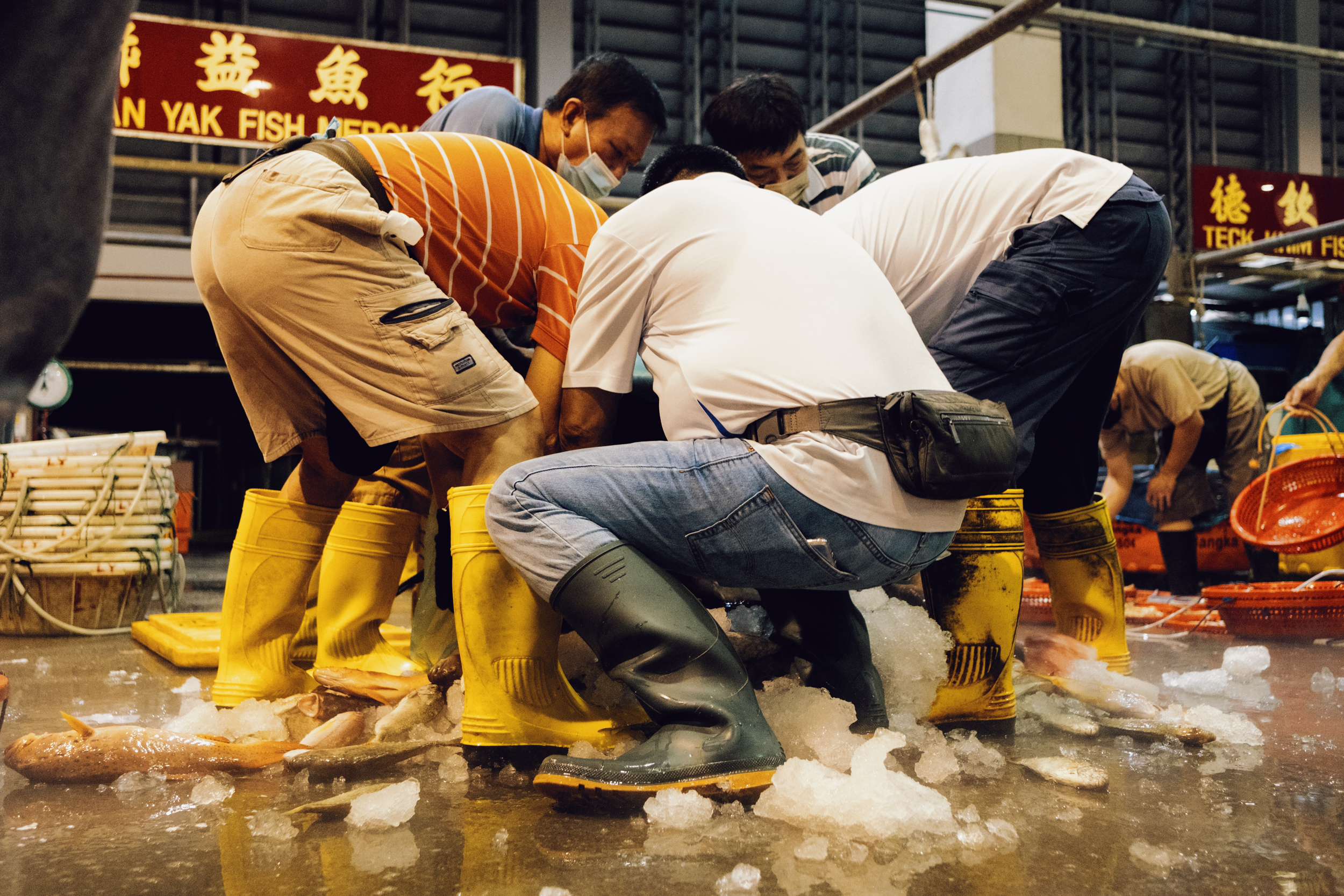 Customers and workers help to empty the tubs contents onto the ground.
