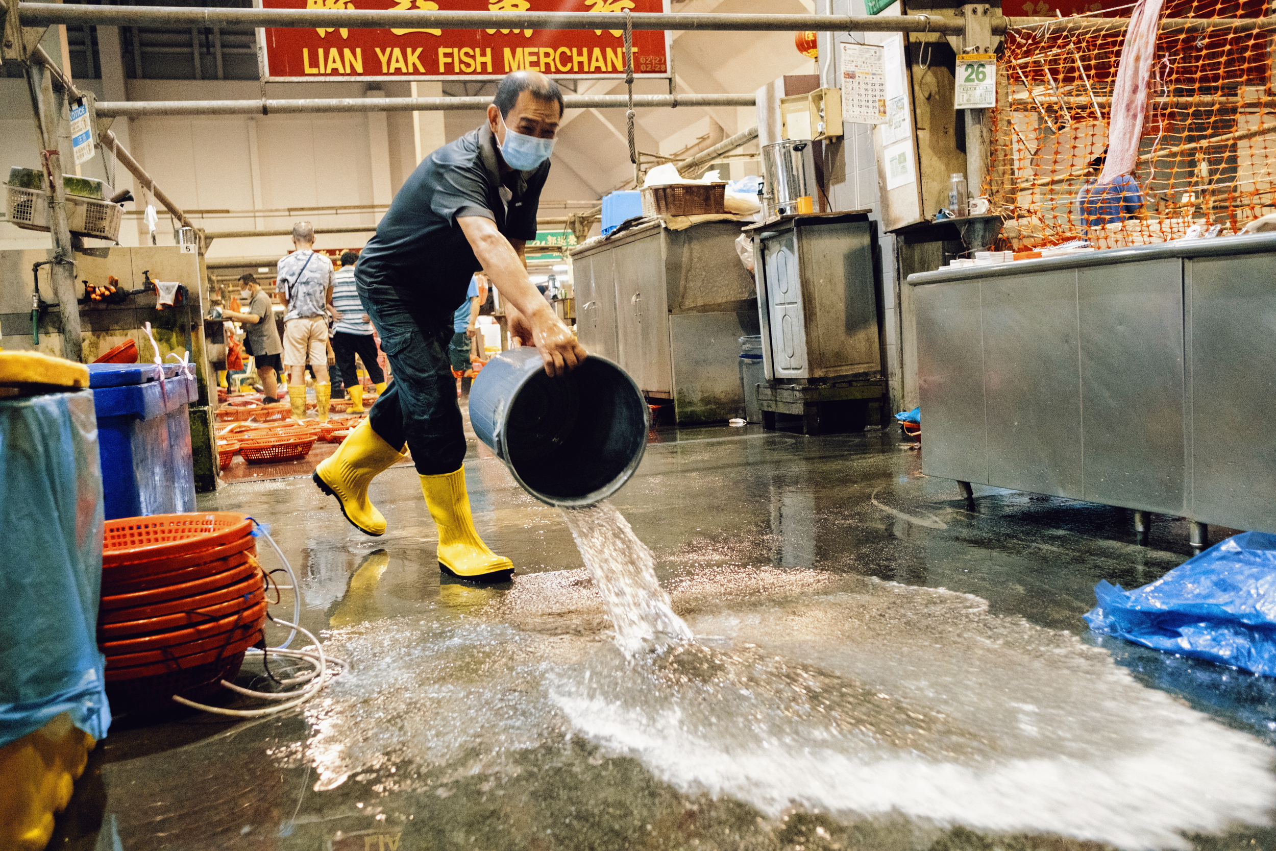 A worker cleans Lian Yak's stall.