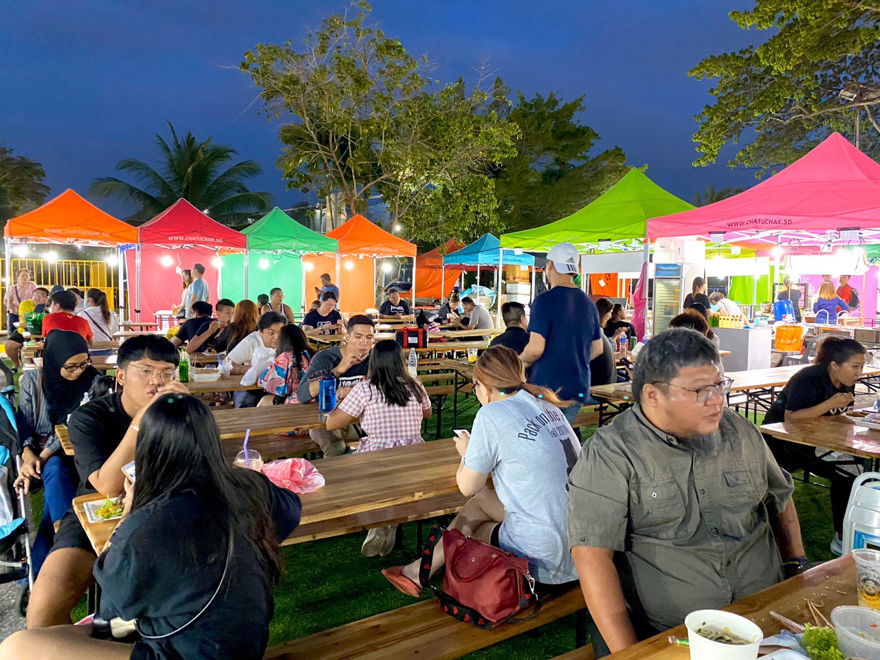 People sitting down at Chatuchak Market in Singapore