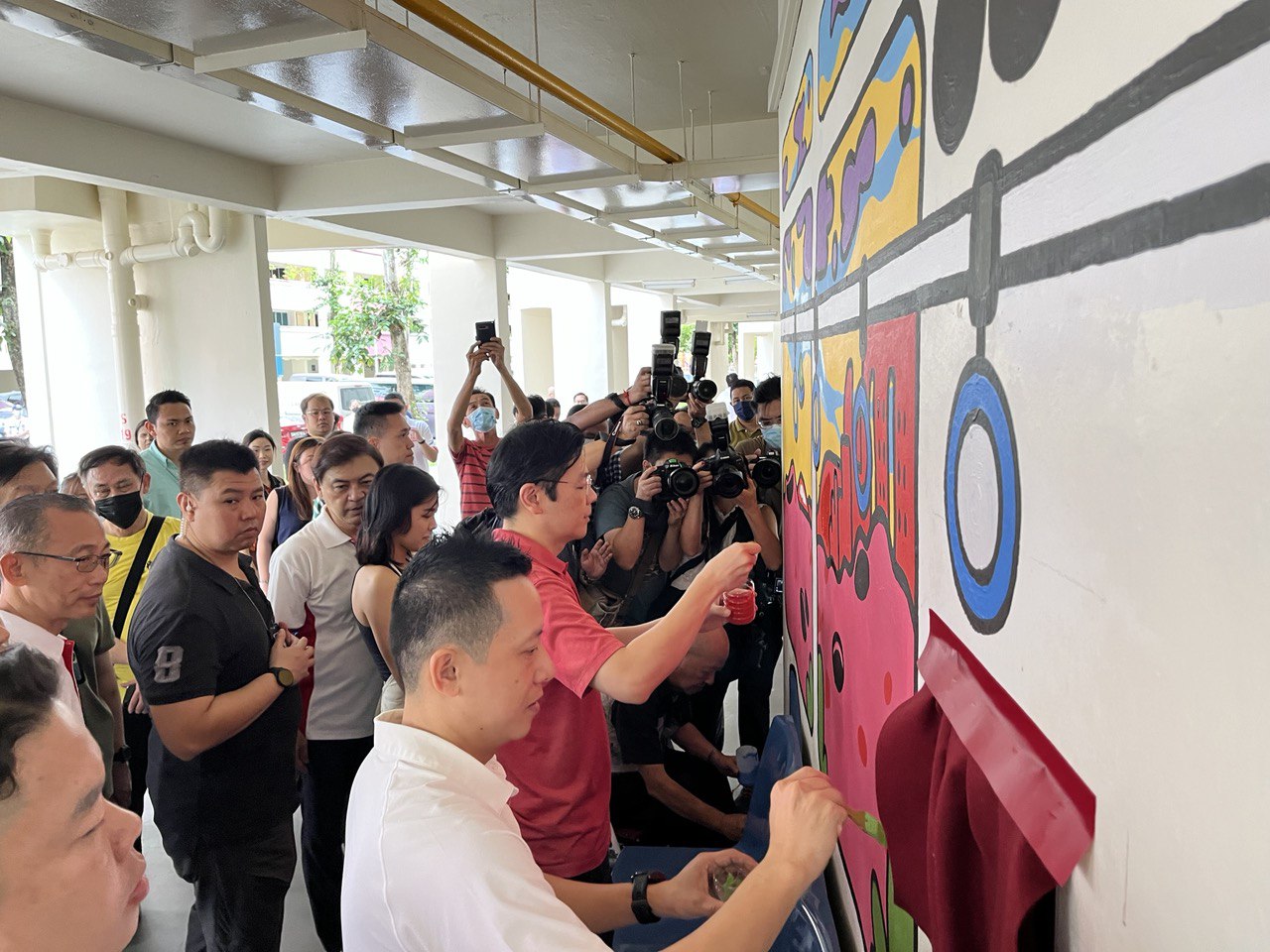 Lawrence Wong painting a mural