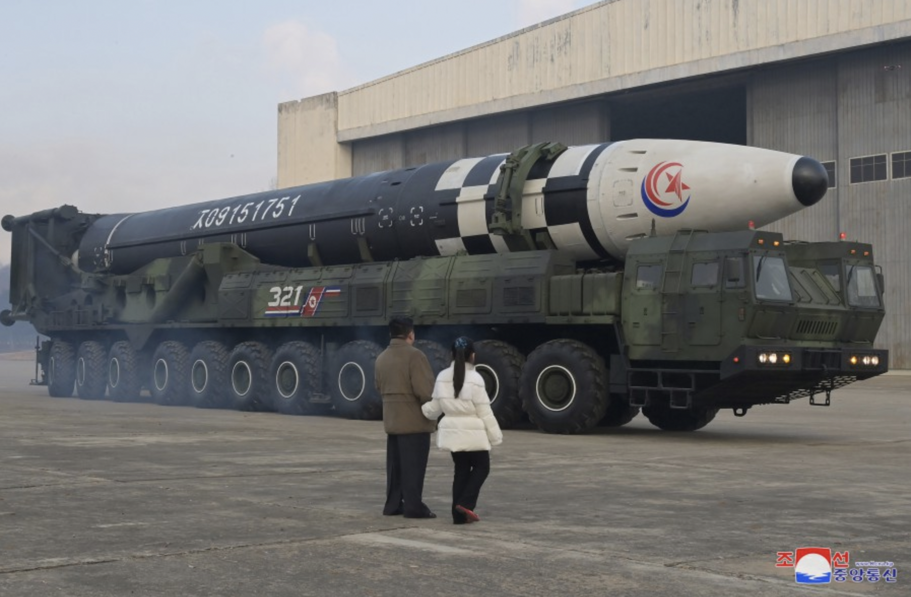 Kim and his daughter inspect the missile