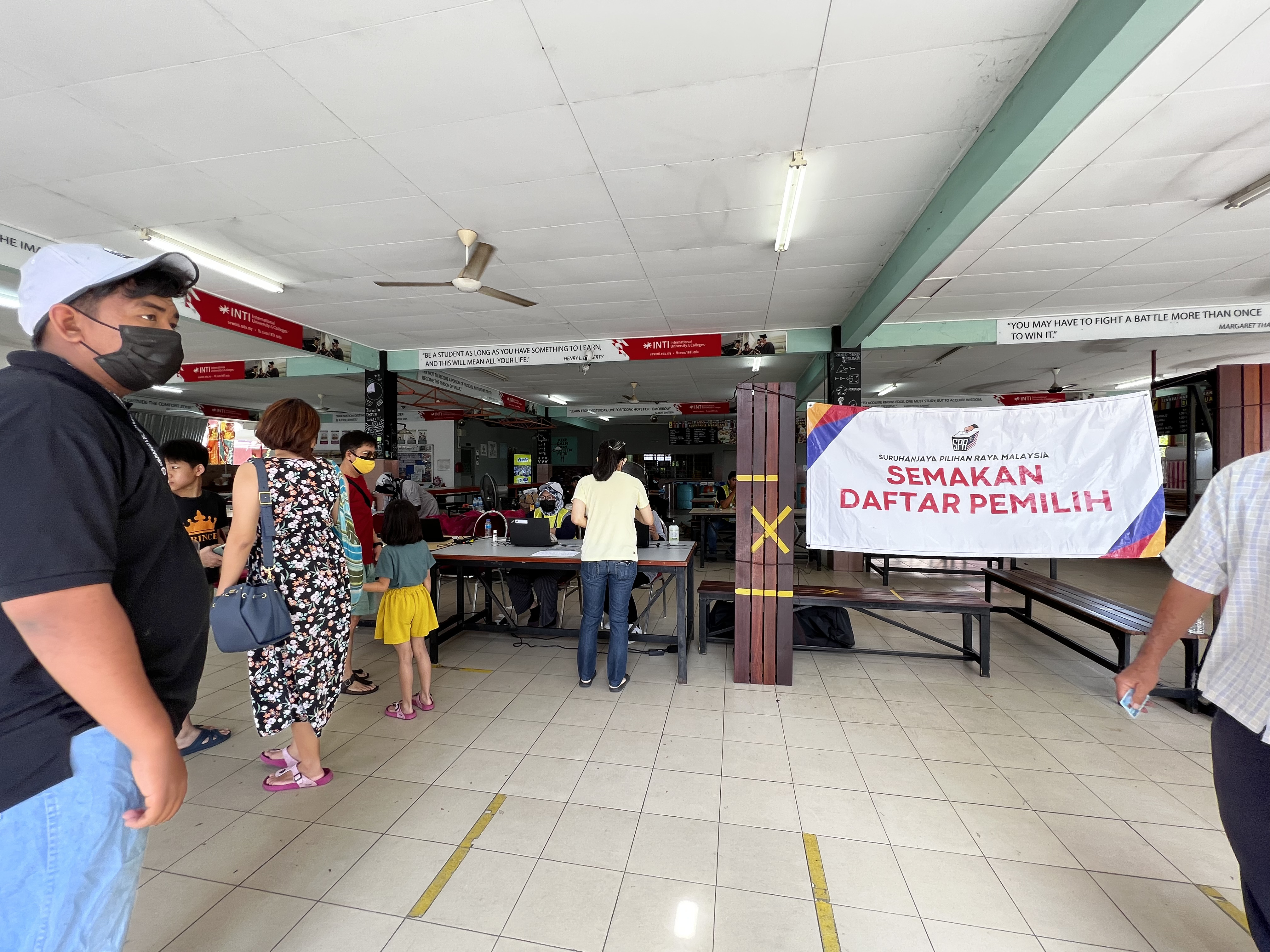 Voters queue up at a school to cast their ballot