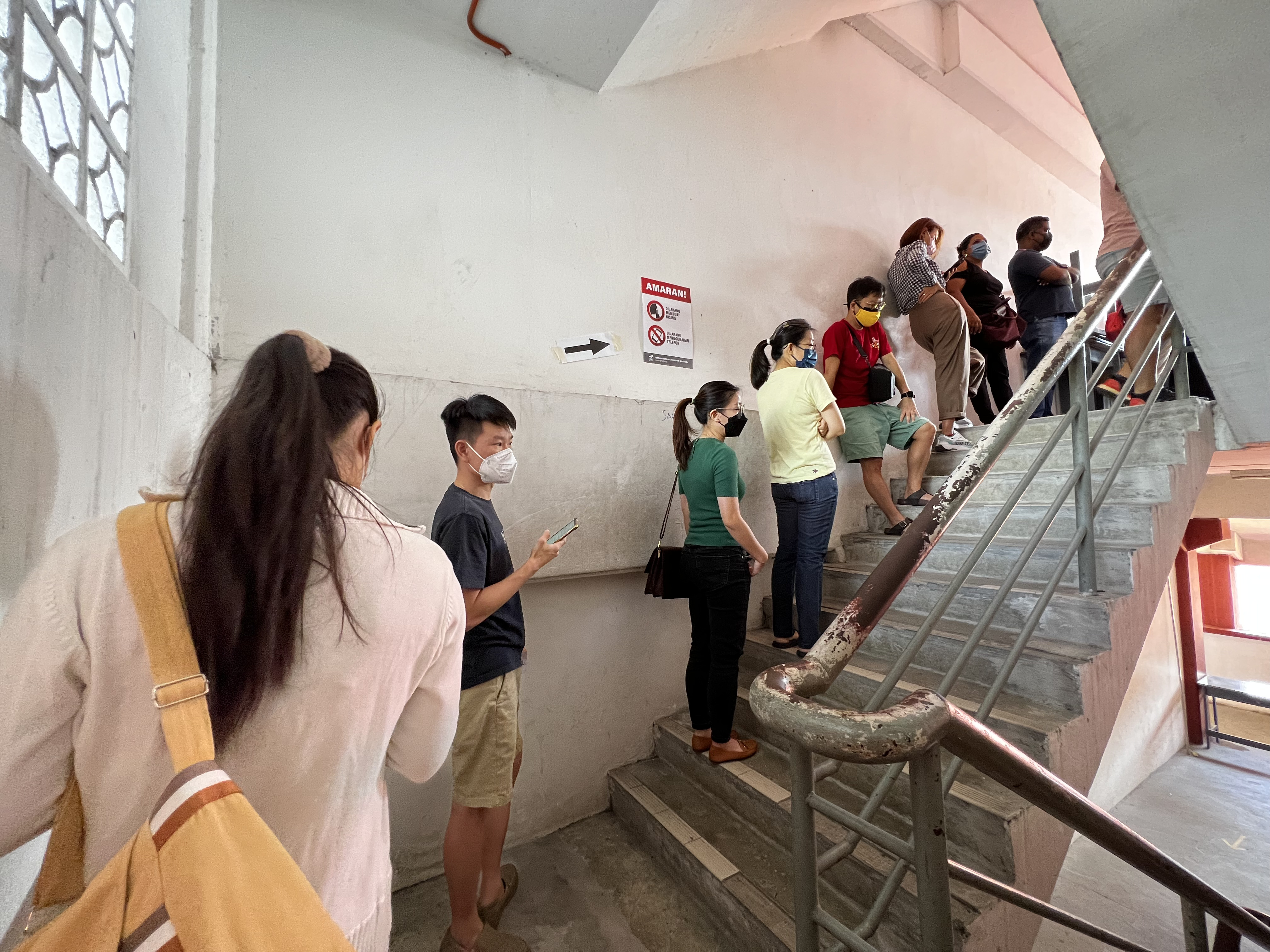 Voters queue up at a school to cast their ballot