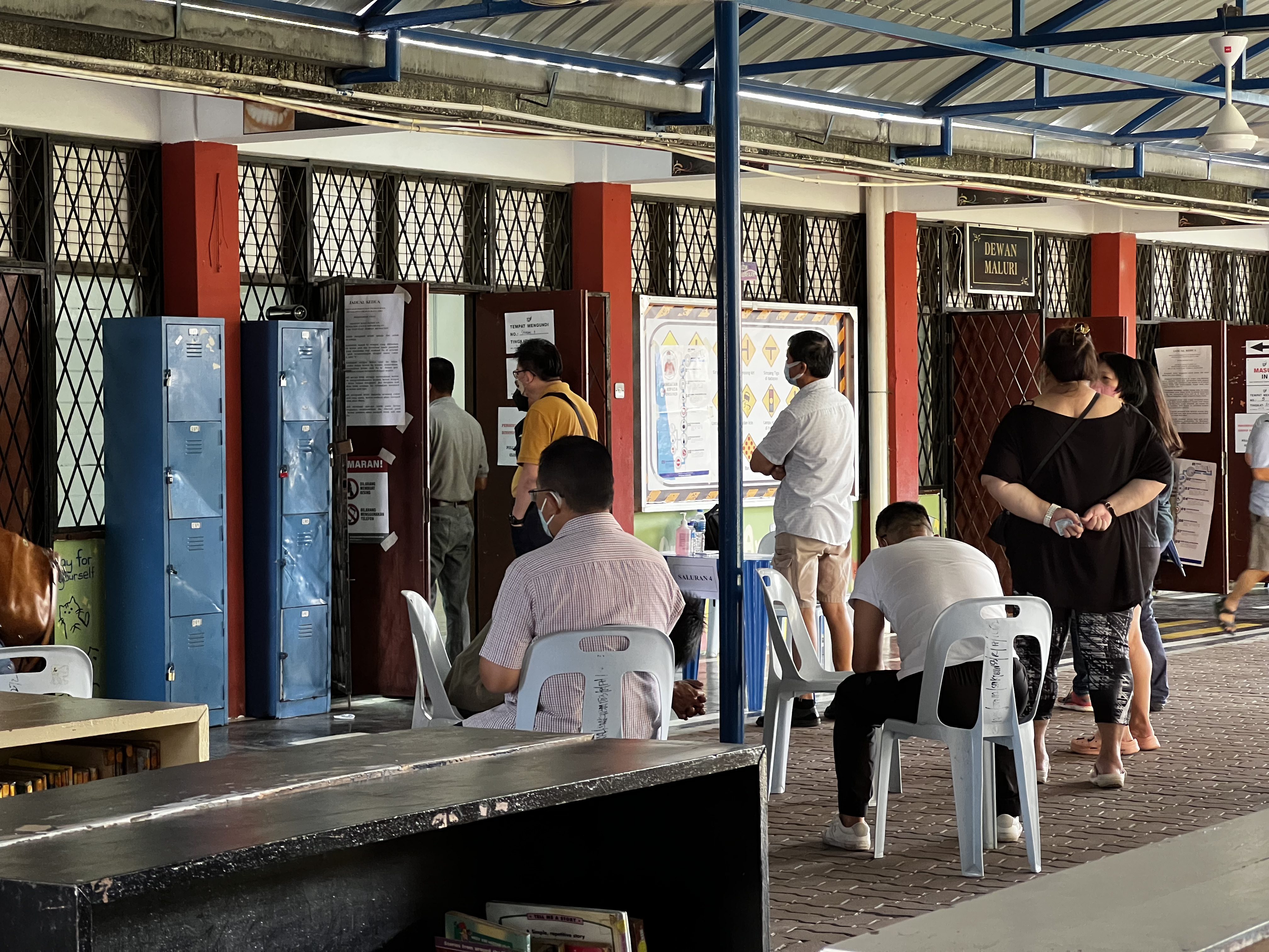 Voters queue up at a school to cast their ballot