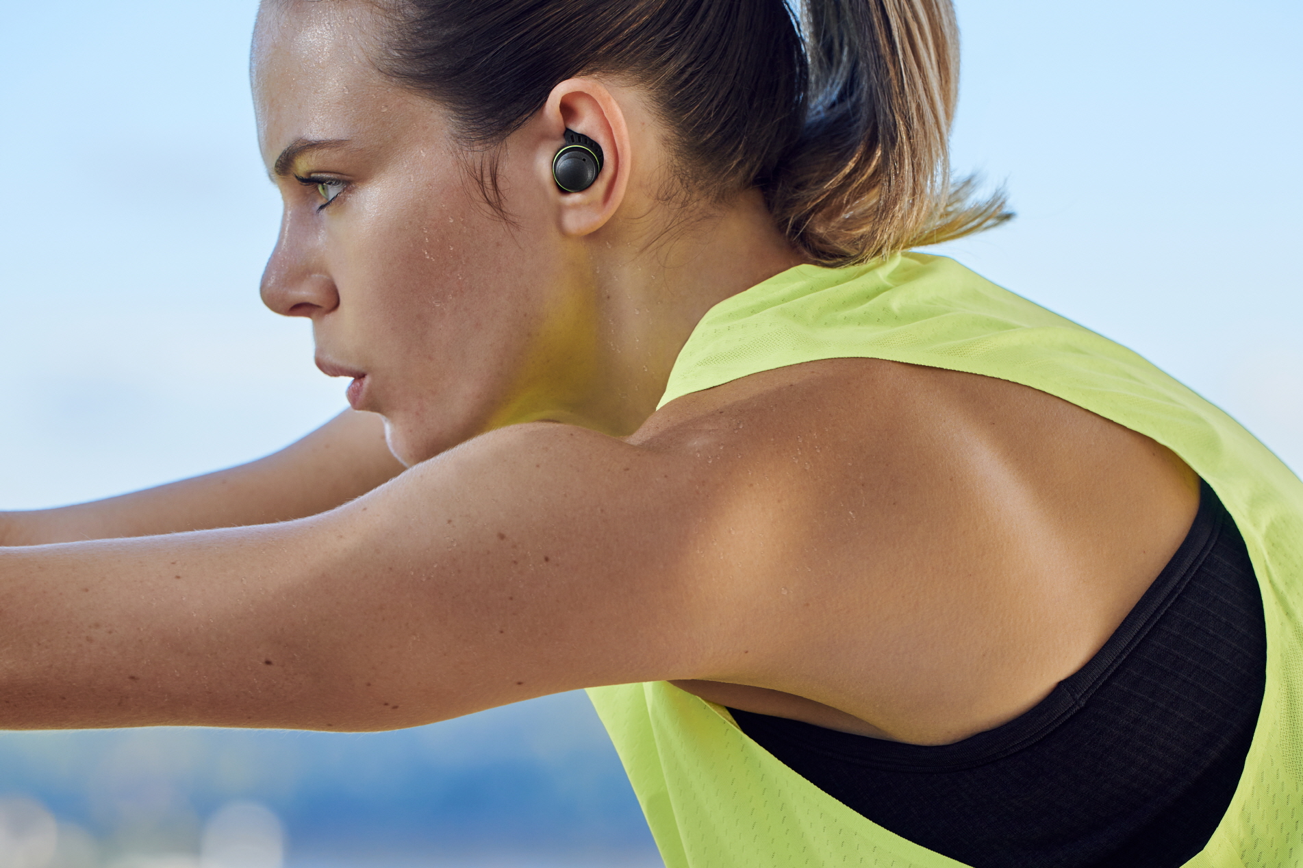 image of woman exercising with earbuds on