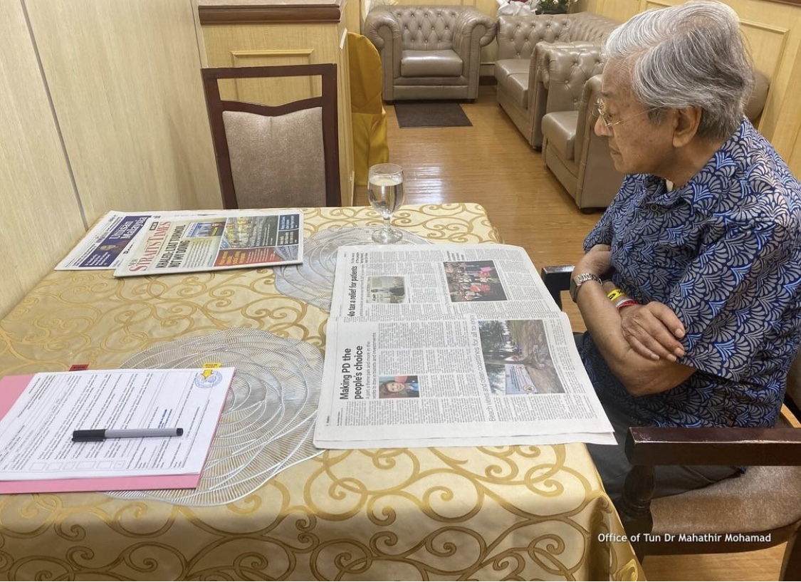 The former PM reading a newspaper at IJN.