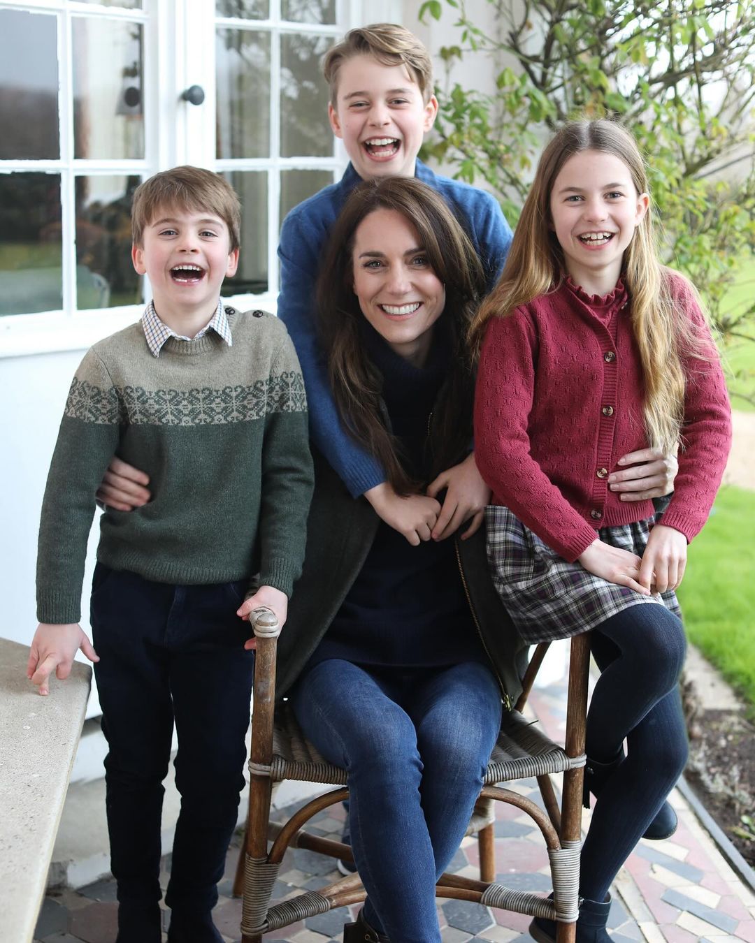 Kate Middleton laughing with her three children.