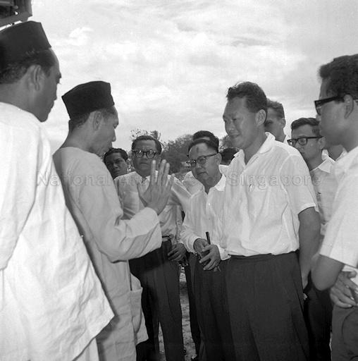 Prime Minister Lee Kuan Yew and social affairs minister Othman Wok meeting community leaders in troubled spots during the racial riots.