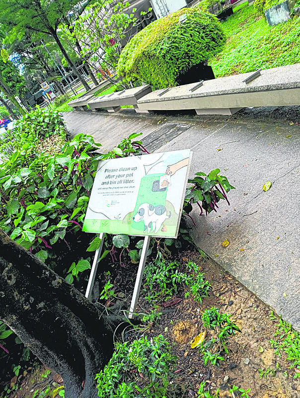 elderly man never pick up dog poo signboard